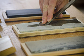 Honing Or Chisel Sharpening On A Set Of Oil Stones
