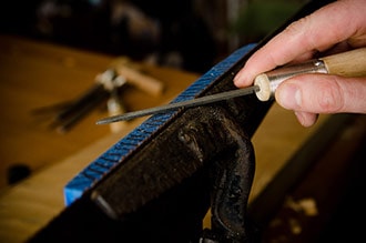 Hand Saw Sharpening With A File On A Cast Iron Saw Vise