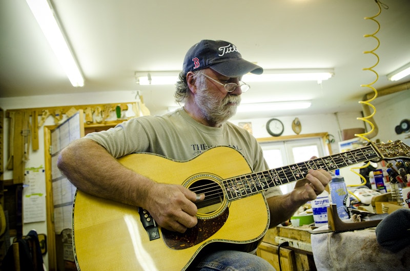 Wayne Henderson Playing A Guitar In The Wayne Henderson Guitars Shop