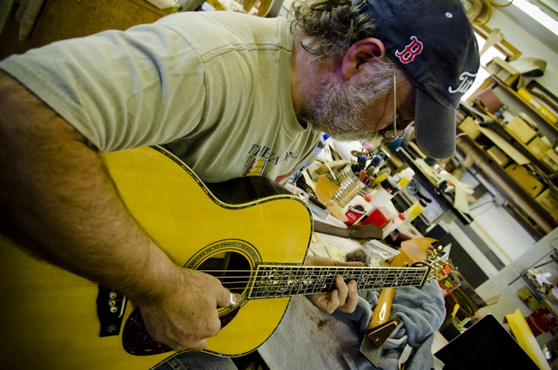 Wayne Henderson Playing A Guitar In The Wayne Henderson Guitars Shop
