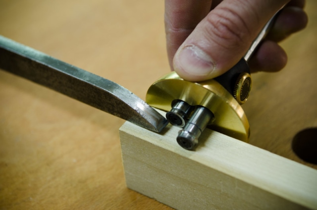 Using A Mortise Gauge To Mark A Mortise Size Next To A Mortise Chisel On A Mortise And Tenon Joint