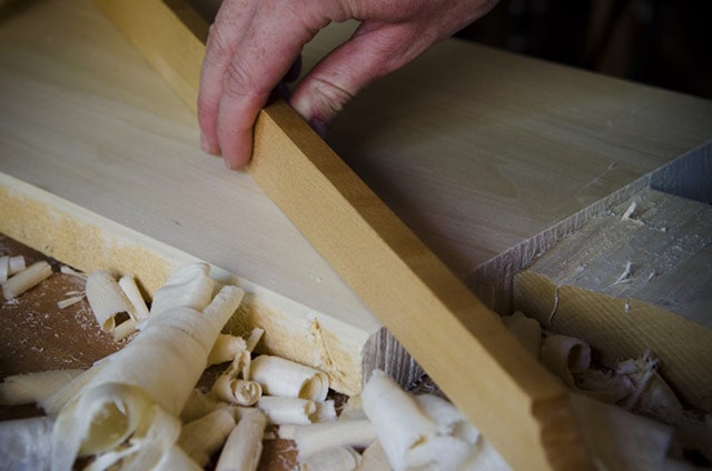 Joshua Farnsworth Using A Wooden Straight Edge To Flatten Board 
