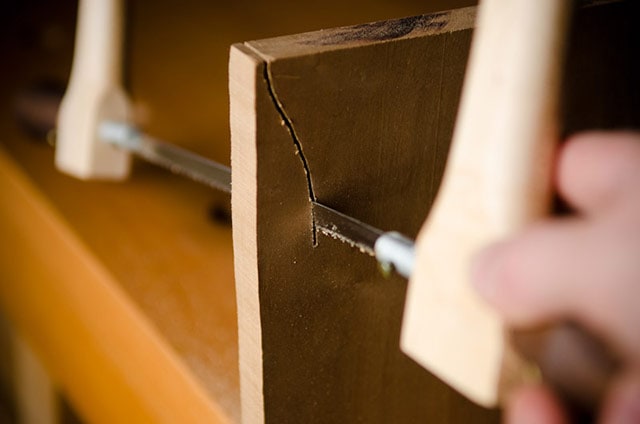 Bow Saw Web (Blade) Cutting A Curve In A Piece Of Cherry Wood In A Woodworking Workbench Vise