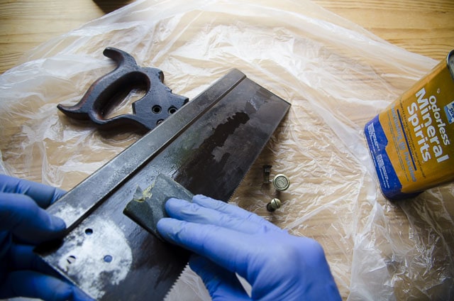 Cleaning An Antique Simonds 97 Back Saw Plate With Mineral Spirits And Sandpaper On A Woodworking Workbench