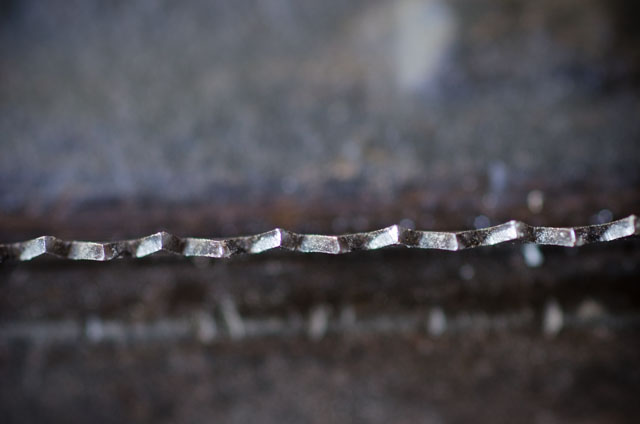 Overhead Macro View Of Hand Saw Teeth That Have Been Set 