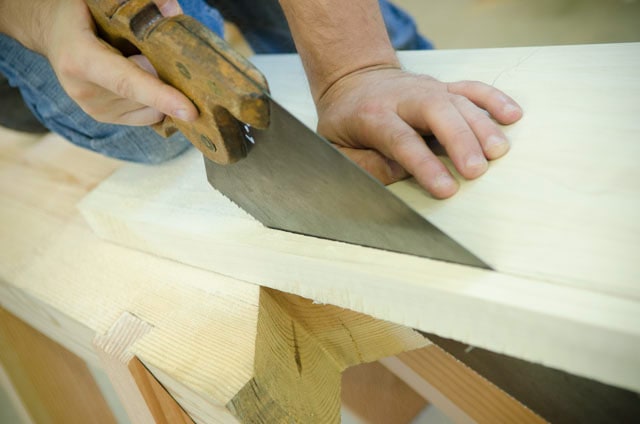 Using A Hand Saw To Rip Cut A Board