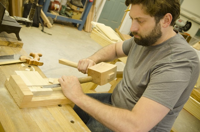 Bearded Woodworking Student Using A Chisel And Joiner'S Mallet To Cut A Dado Joint