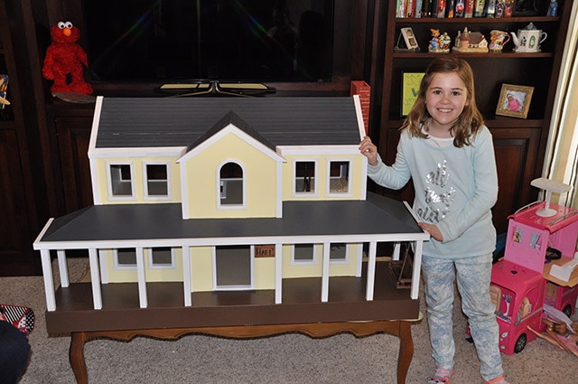 Little Girl With A Yellow Doll House Built By James Huggett 