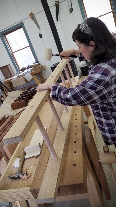 Woman Using A Mallet To Fit An Oak Ladder Together