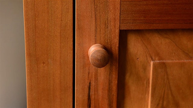 Cherry Shaker Knob On A Frame And Panel Door Of A Cupboard