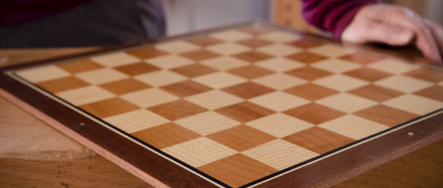 Dave Heller Holding A Veneered Chess Board With Mother Of Pearl Inlay