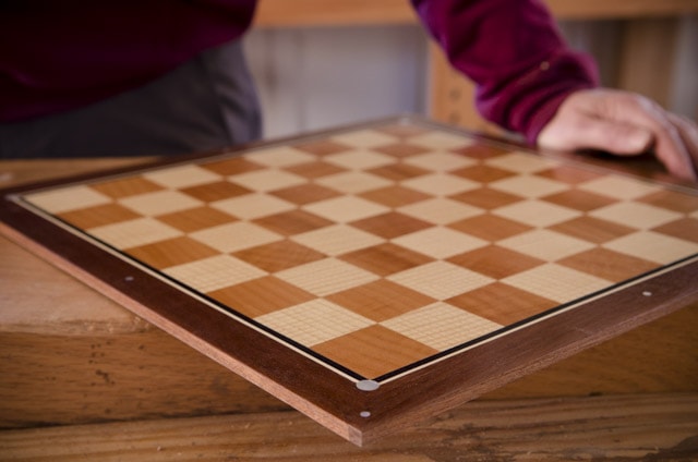 Dave Heller Holding A Veneered Chess Board With Mother Of Pearl Inlay