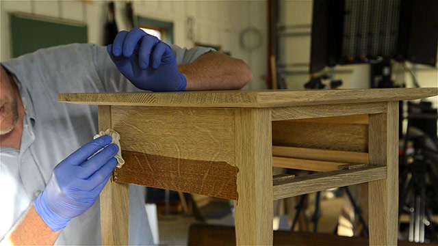 Joshua Farnsworth Applying Wood Finish To An Oak Table Apron With Wood Figure In His Woodworking Workshop