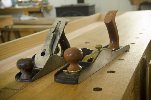 Two Hand Planes Sitting On A Woodworking Workbench Stanley Number 3 Smoothing Plane And Lie-Nielsen Number 62 Low Angle Jack Plane