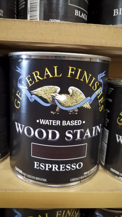 Gallon Can Of General Finishes Water Based Wood Stain Espresso Color Sitting On A Shelf In A Woodworking Store