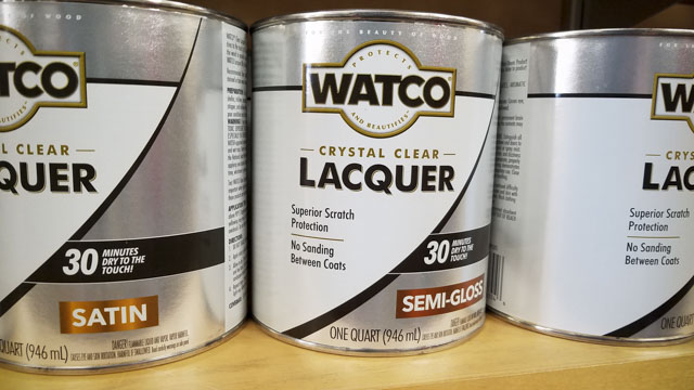 Gallon Cans Of Watco Crystal Clear Wood Finish Sitting On A Shelf In A Woodworking Store