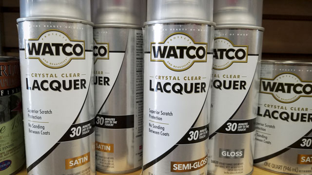 Aerosol Spray Cans Of Watco Crystal Clear Wood Finish Sitting On A Shelf In A Woodworking Store