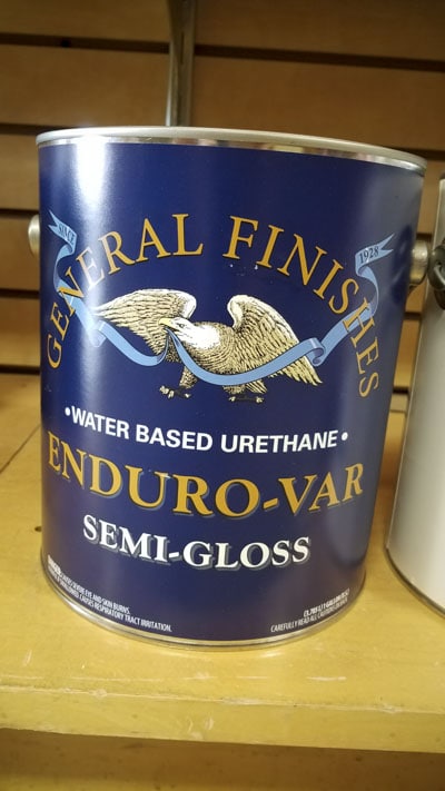 Gallon Can Of General Finishes Water Based Urethane Enduro-Var Semi-Gloss Finish Sitting On A Shelf In A Woodworking Store