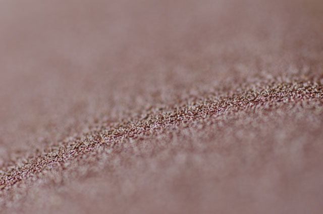 Macro closeup photo of 150 grit sandpaper surface