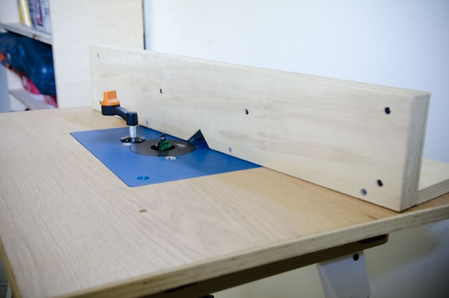 Router Table With Blue Insert And Wooden Fence