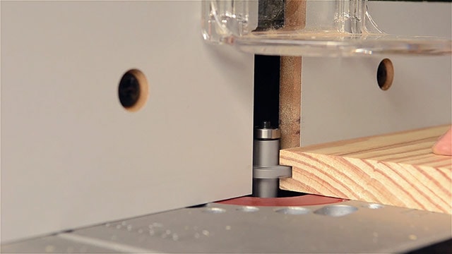 Woodworker Cutting A Groove In A Board On A Router Table For A Tongue &Amp; Groove Joint