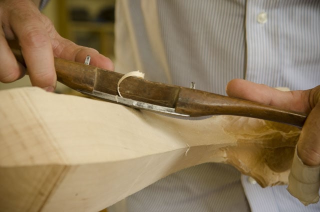 Woodworker Using An Antique Wooden Spokeshave To Fair Out Curves On A Ball And Claw Foot