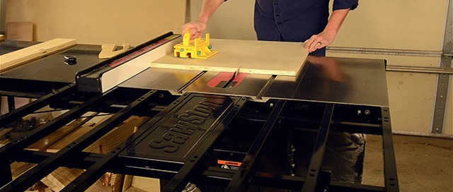 Sawstop Folding Outfeed Table Being Used To Cut A Sheet Of Plywood On A Table Saw