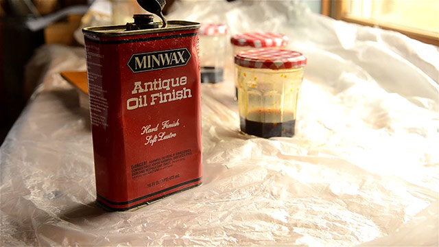 Jar Of Minwax Antique Oil Finish With Jars Of Aniline Dye In The Background