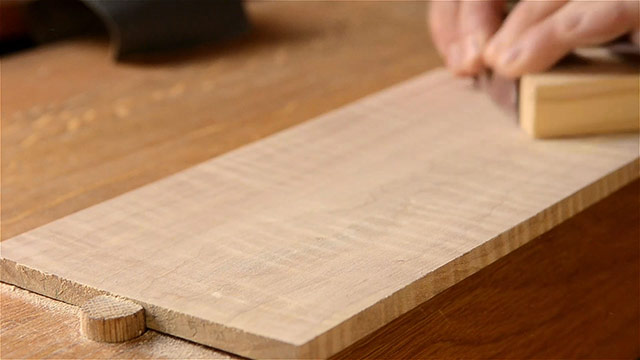 Sanding Curly Figured Maple Board On A Woodworking Workbench