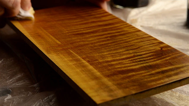 Wiping Boiled Linseed Oil Onto A Curly Maple Board That Has Been Colored With Aniline Dyes