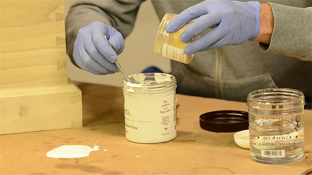 Mixing Yellow Paint Pigment Into Powdered Milk Paint In A Plastic Container