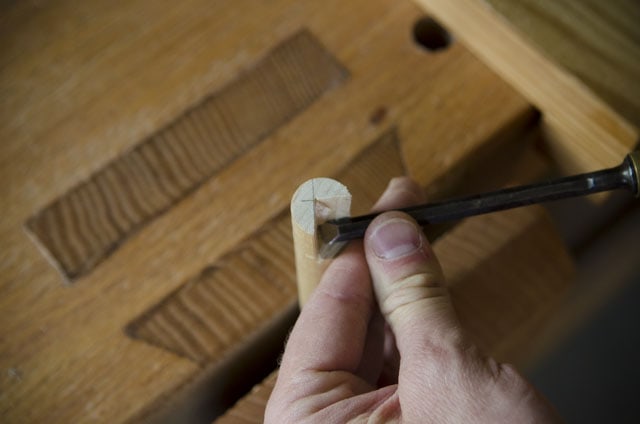 Using A Chisel To Cut A Notch On A Bench Dog For A Wooden Workbench
