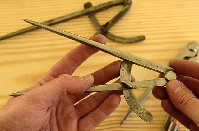 A Thumb Screw Style Pair Of Woodworking Dividers Or Compass With A Collection Of Other Dividers In The Background