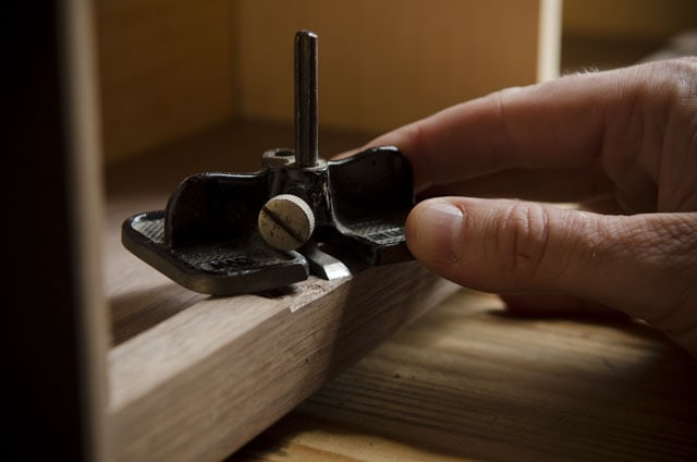 Woodworker Using A Small Router Plane For Hinge Mortise
