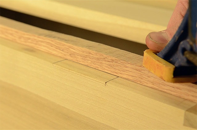 Clamping safety board to prevent blowout when installing butt hinges on a dovetail chest