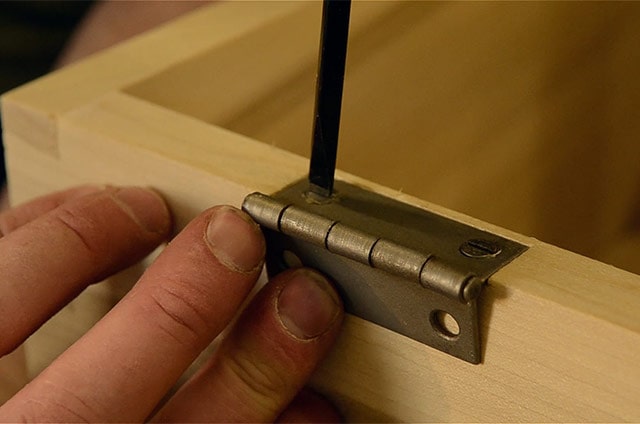 Driving Screws With A Screw Driver While Installing Butt Hinges On A Dovetail Chest