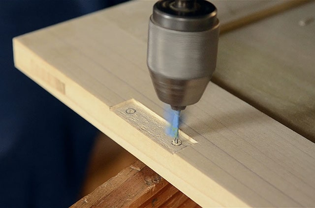 Boring hinge holes marking a mortise with a marking knife and square while Installing butt hinges on the lid of a dovetail chest