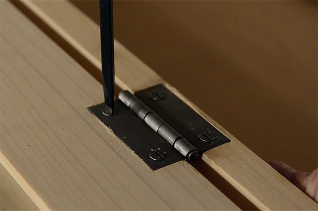 Driving Screws On A Chest Lid With A Screw Driver While Installing Butt Hinges On A Dovetail Chest
