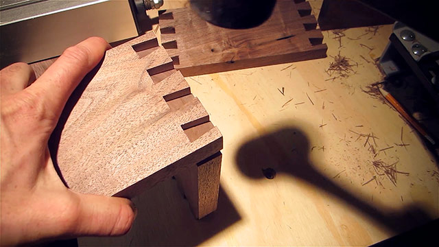 Fitting together walnut dovetails made by a dovetail jig