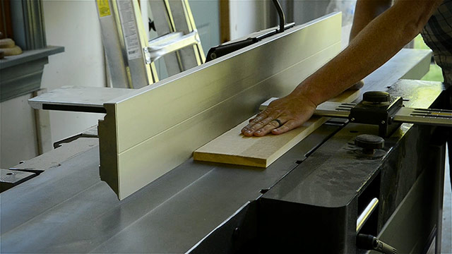 Woodworker Using A Wood Planer To Square Boards For Woodworking