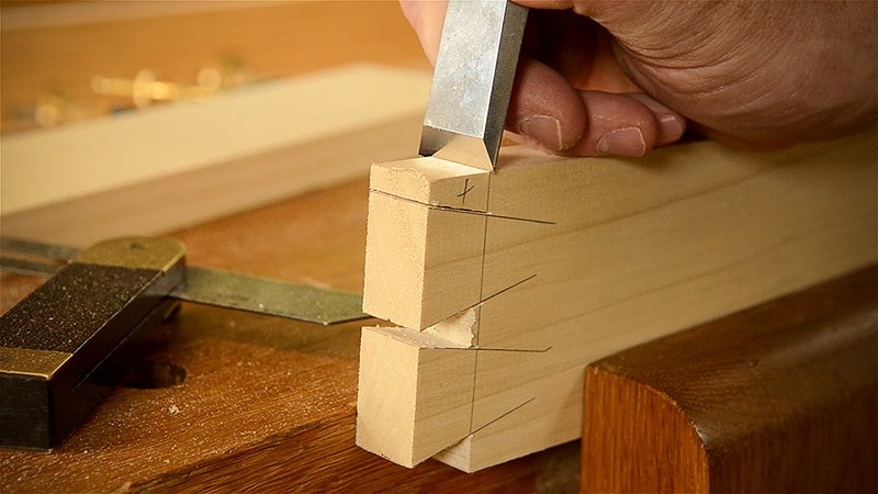 Cutting Dovetails With Woodworking Hand Tools Woodworker Using A Wood Chisel To Trim A Dovetail Joint
