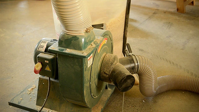 Grizzly Dust Collector Motor And Hoses In Woodworking Shop