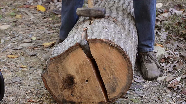 Using A Wood Splitting Wedge To Split A Log