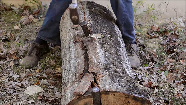 Split A Log With A Wood Splitting Wedge And Sledge Hammer 