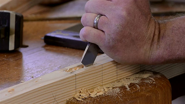 Using A Bench Chisel To Pare The Side Walls Of A Mortise Joint