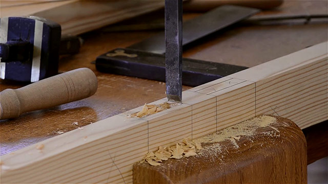 Using A Bench Chisel To Pare The Ends Of A Mortise Joint