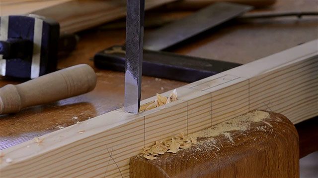 Using A Bench Chisel To Pare The Ends Of A Mortise Joint