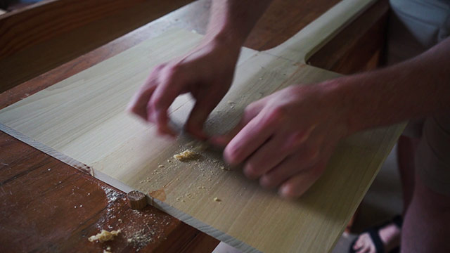 Using A Card Scraper On A Wooden Pizza Peel 