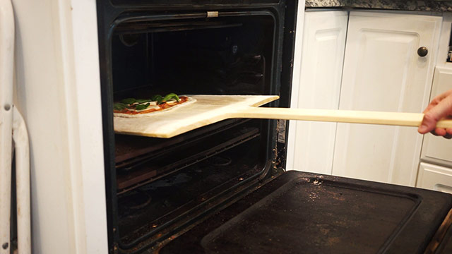 Using A Wooden Pizza Peel To Bake Loaves Of Pain À L’ancienne French Bread