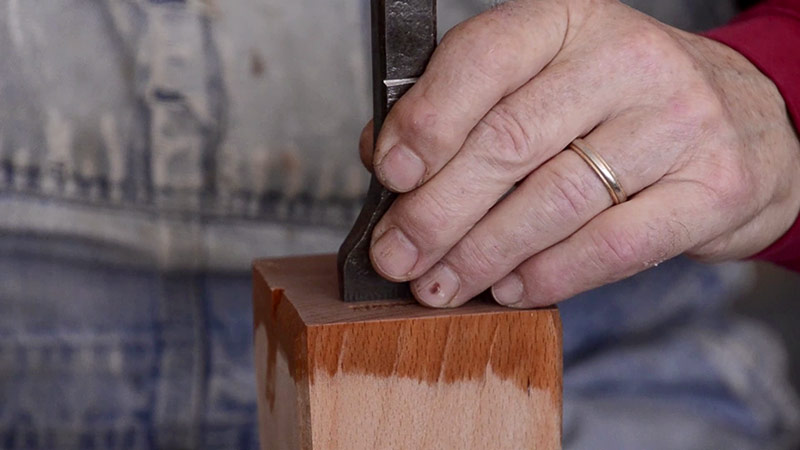 Bill Anderson Hand Stamping His Name On A Wood Plane